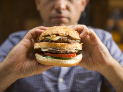 man holding a big hamburger
